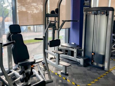 Sunlight streaming through large windows in a gym.